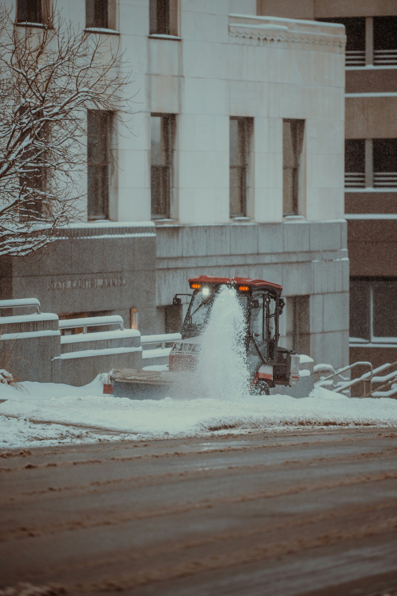 Snow removal equipment clearing a commercial building entrance